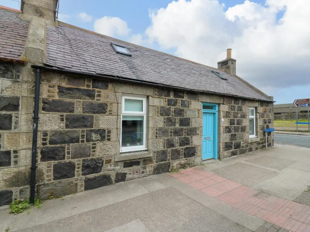 an old stone building with a blue door at 2 College Bounds in Fraserburgh