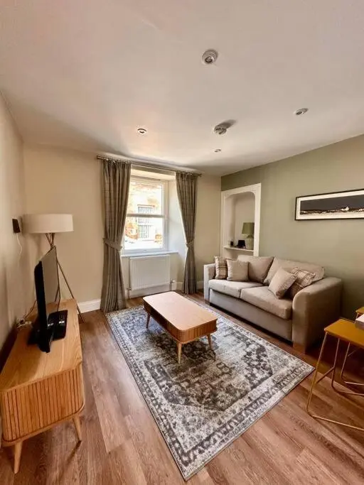 a living room with a couch and a table at Warm and Cosy City Centre House in Inverness