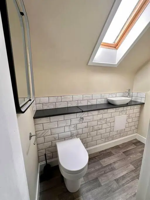 a bathroom with a white toilet and a sink at Warm and Cosy City Centre House in Inverness