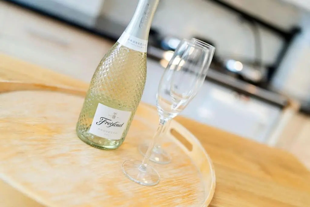 a bottle of champagne sitting next to a wine glass at Westerpark Cottage, Pet & Family Friendly Countryside Retreat, Aberdeenshire in Huntly