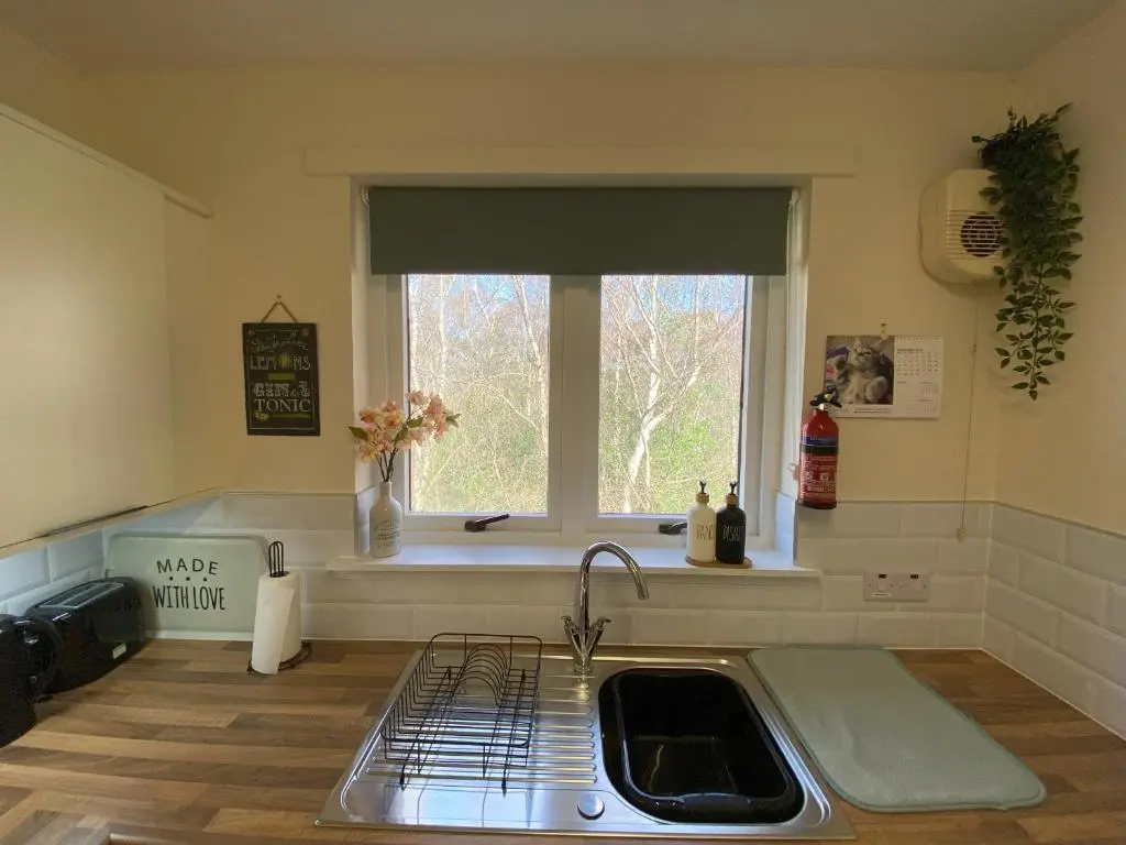 a kitchen with a sink and a window at Treetops - Bright 2 Bed Flat - Super Location in Inverness