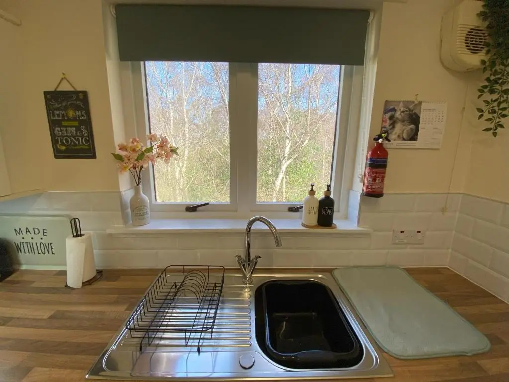 a kitchen with a sink and a window at Treetops - Bright 2 Bed Flat - Super Location in Inverness