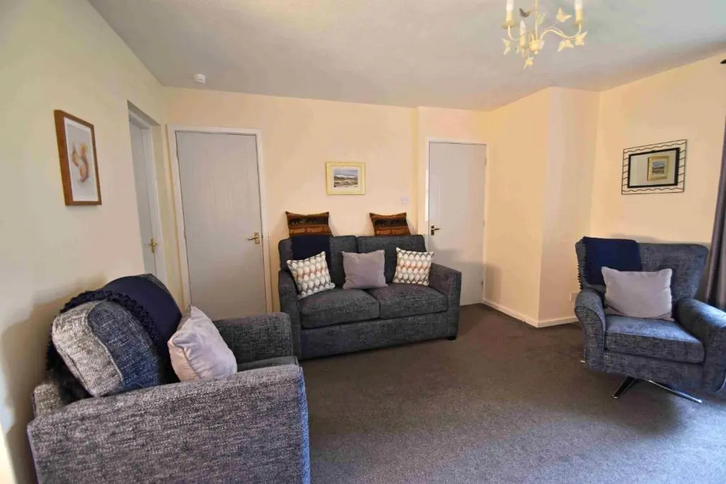 a living room with two chairs and a couch at Birch View in Aviemore