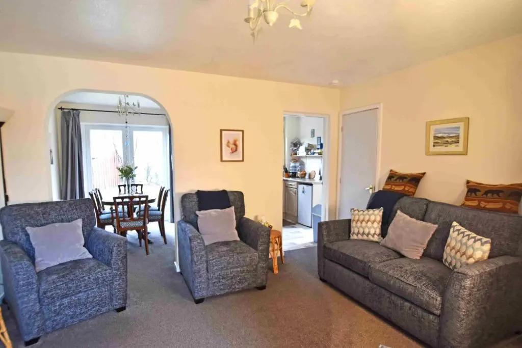 a living room with two couches and a table at Birch View in Aviemore