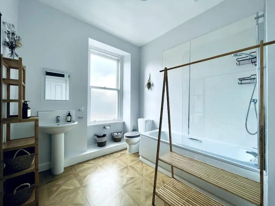 a bathroom with a tub and a toilet and a sink at Charming 3-bedroom maisonnette in Inverness City Centre in Inverness