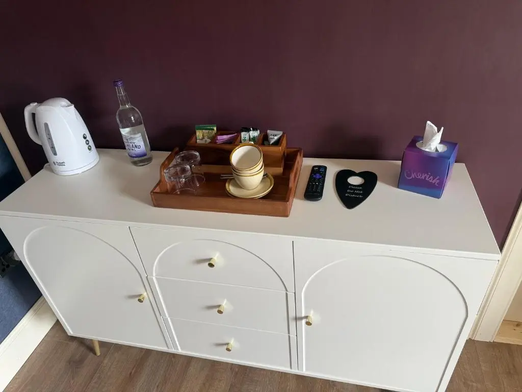 a white dresser with a bottle of soap and a box at The Salt house in Golspie