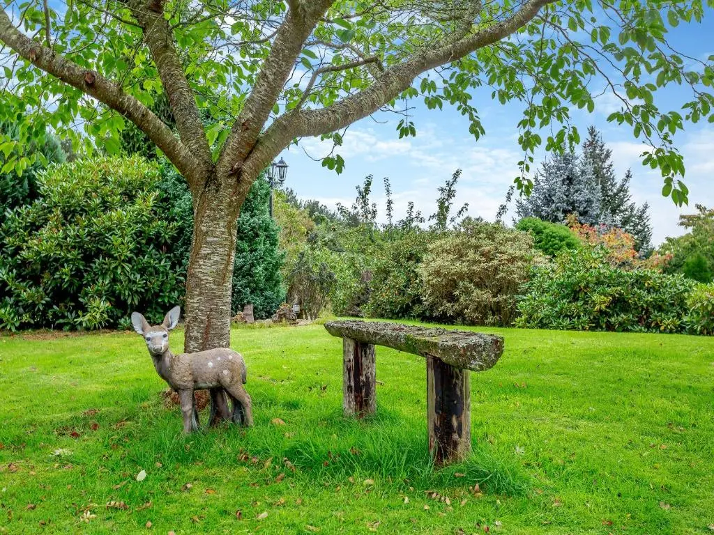 a statue of a deer next to a stone bench at Drummond House Uk42979 in Brackley