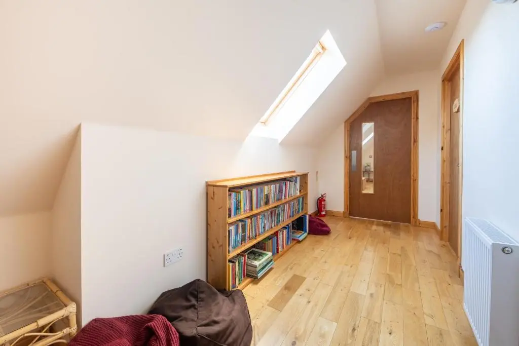 a room with a book shelf and a window at Spacious 6 bedroom property on a working fruit farm in Tore