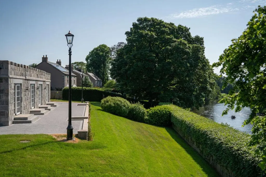 a street light in the grass next to a river at The Forbes Arms Hotel in Alford