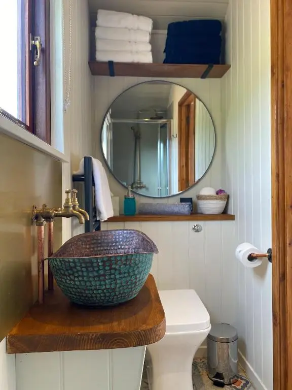 a bathroom with a bowl sink and a mirror at Ledmacoy Shepherds Huts in Strathdon