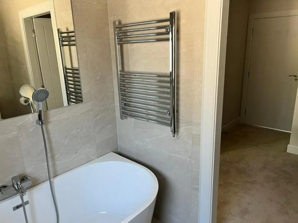 a bathroom with a toilet and a shower and a mirror at Dune House, Golf Road, Dornoch 5x Bedrooms in Dornoch