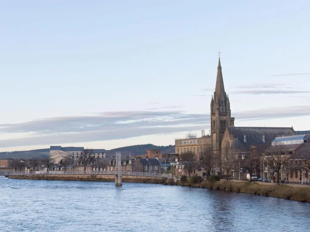 a city with a river and a church with a tower at Holiday Home Kincraig by Interhome in Inverness