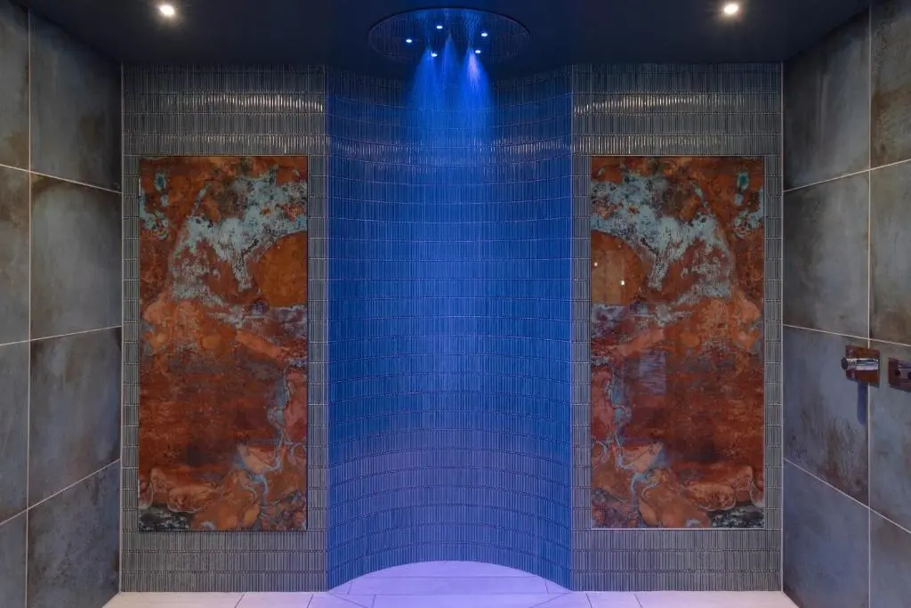 a shower with blue tiles in a room at Golf View Hotel & Spa in Nairn