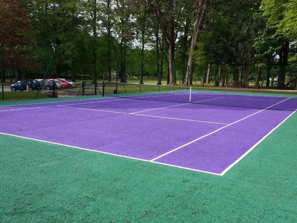 a purple and green tennis court in a park at Courtyard Cottage 3, Riverside Cottage in Fort Augustus