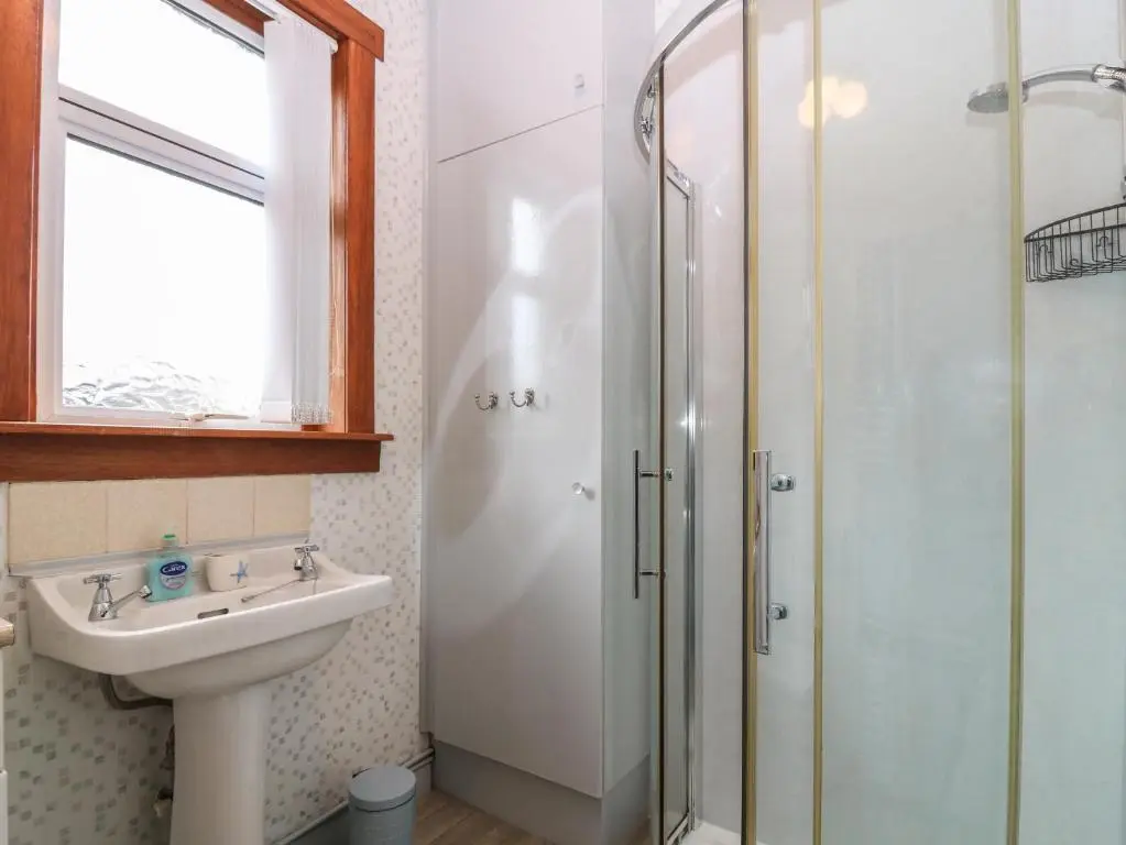 a bathroom with a sink and a shower at Thain House in Banff