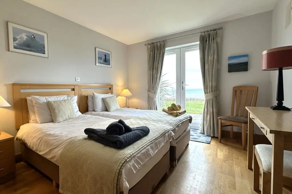a bedroom with a bed with a towel on it at No2 The Links Apartment, Brora in Brora