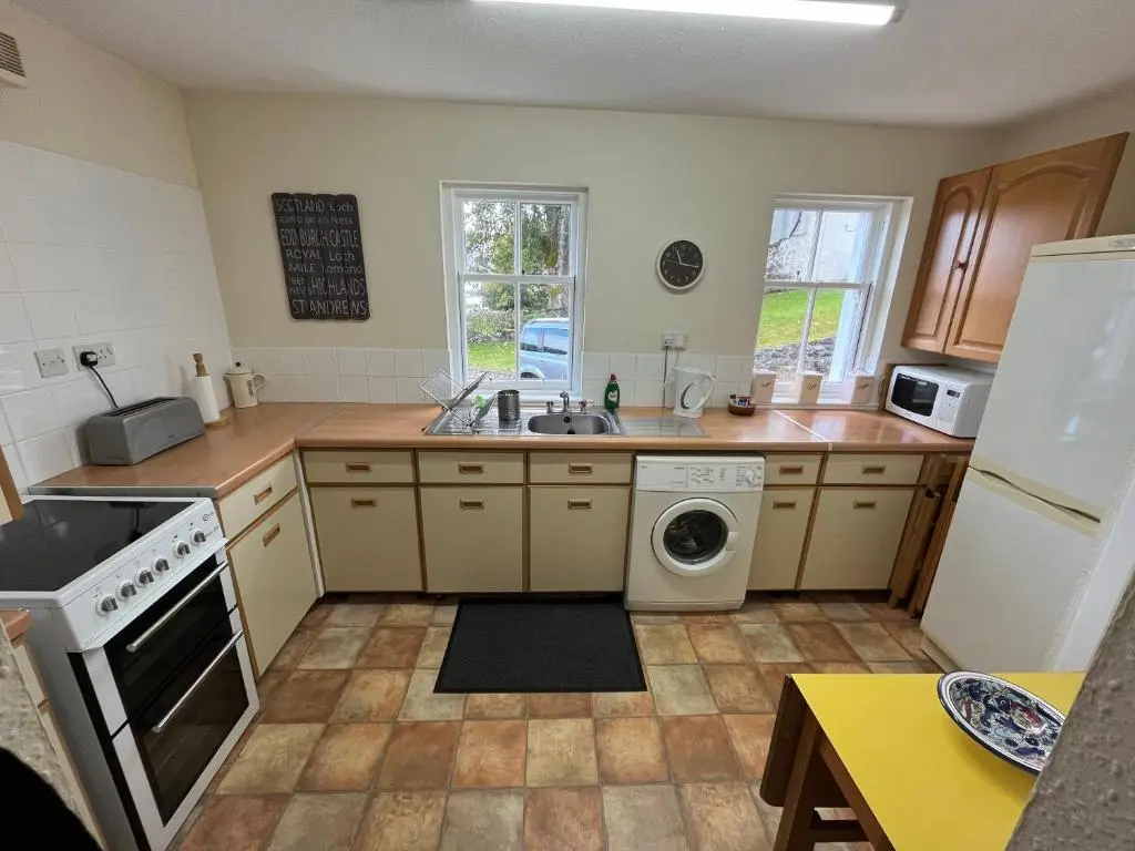 a kitchen with a sink and a dishwasher at Ness View Cottage in Fort Augustus