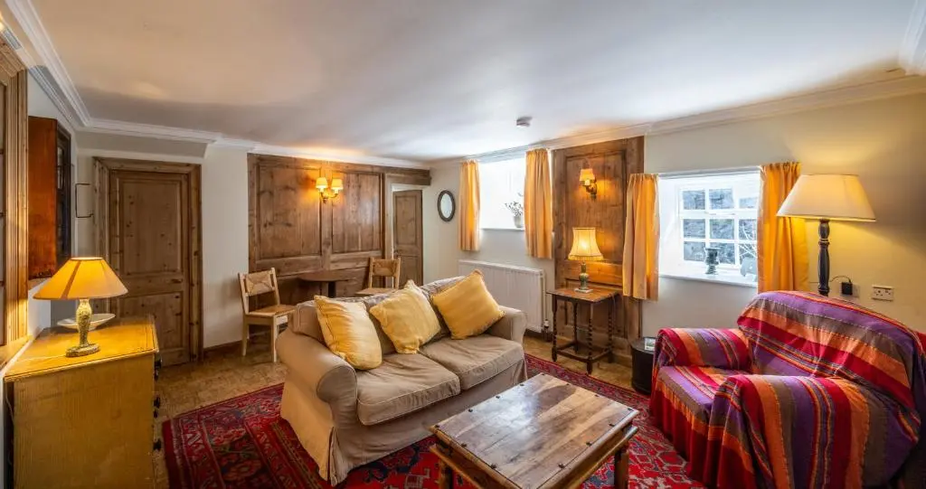 a living room with a couch and a table at 7 Shorehead, Portsoy in Portsoy