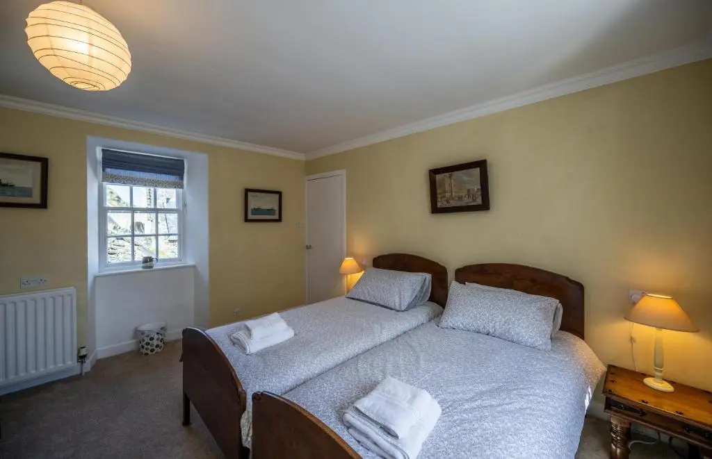 a bedroom with a bed with two pillows on it at 7 Shorehead, Portsoy in Portsoy