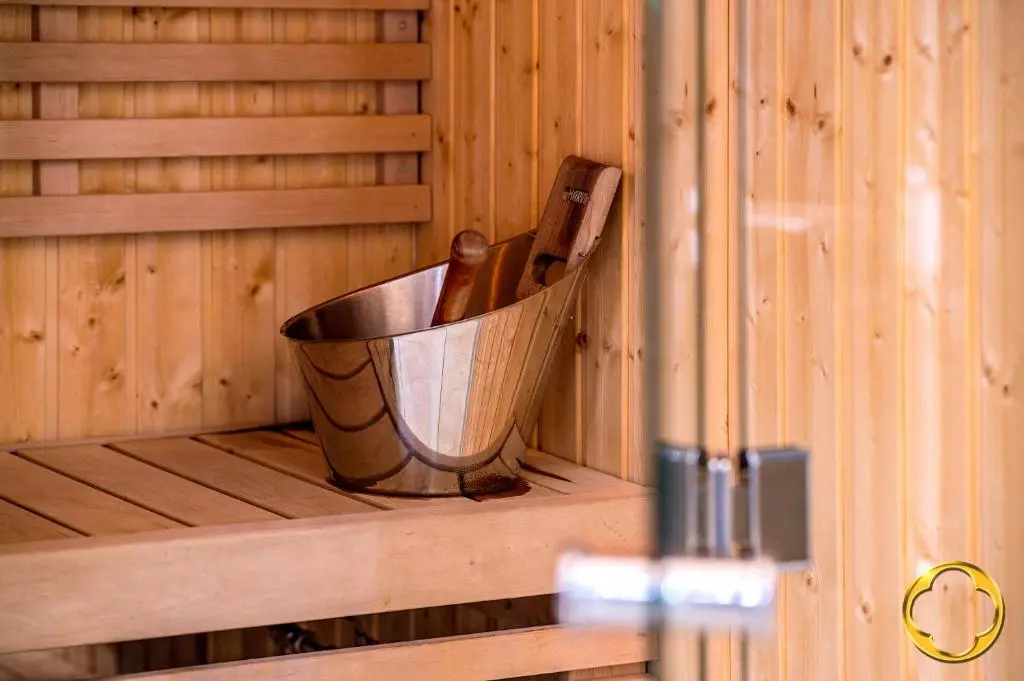 a metal bucket in the corner of a sauna at Highland Club Direct in Fort Augustus