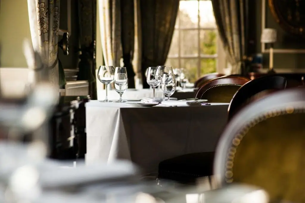 a table with wine glasses on top of it at Thainstone House in Inverurie