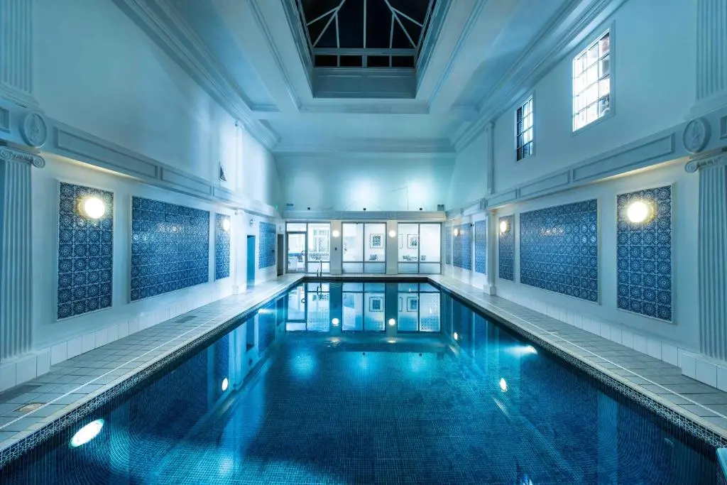 a large swimming pool in a large building at Thainstone House in Inverurie