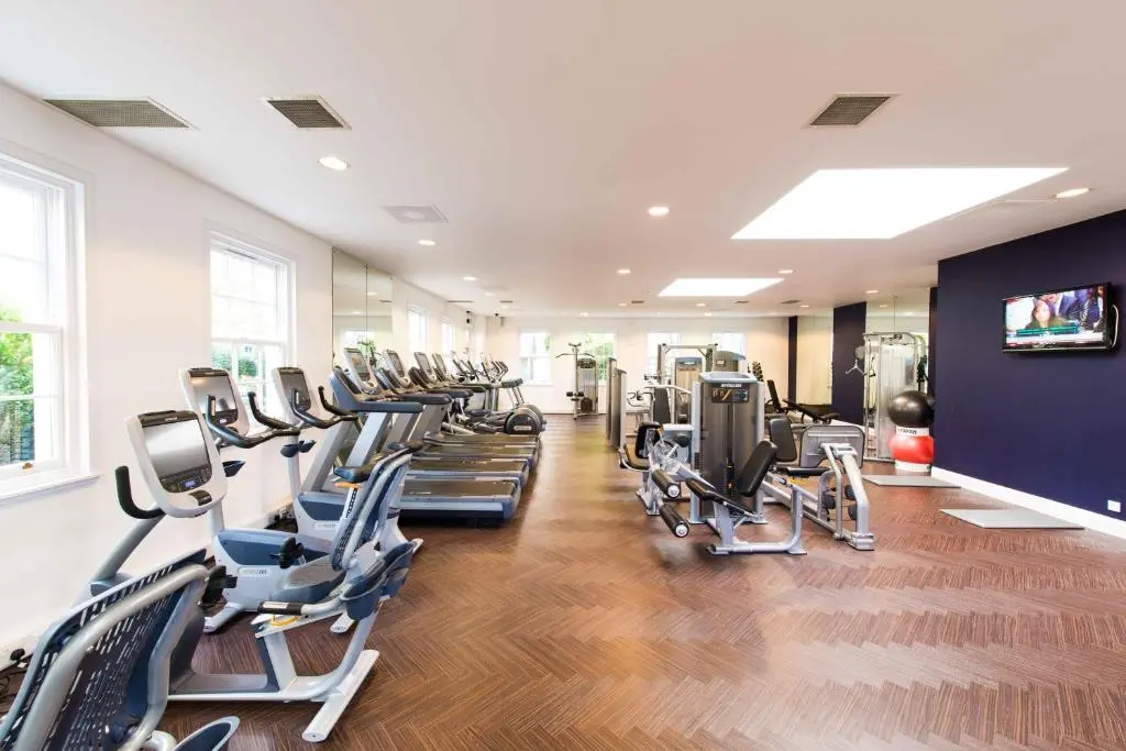 a gym with rows of treadmills and machines at Thainstone House in Inverurie