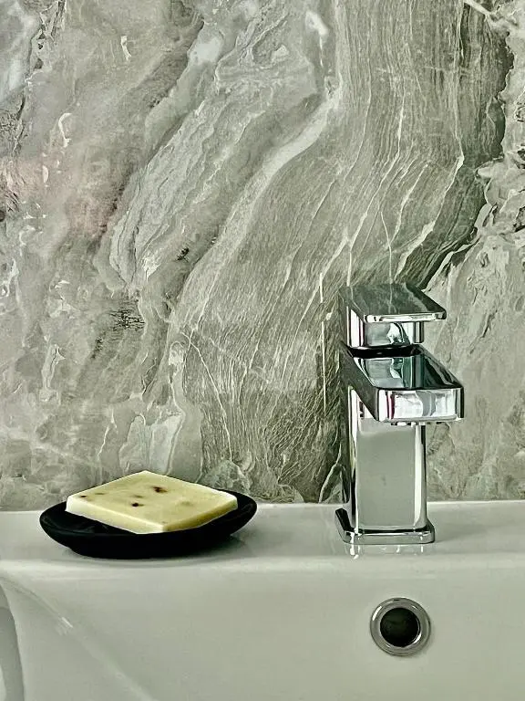 a bathroom sink with a soap dispenser on top of it at Cosy Country House in Deeside in Finzean