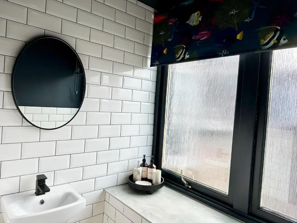 a bathroom with a sink and a mirror at Haugh Hideaway in Inverness