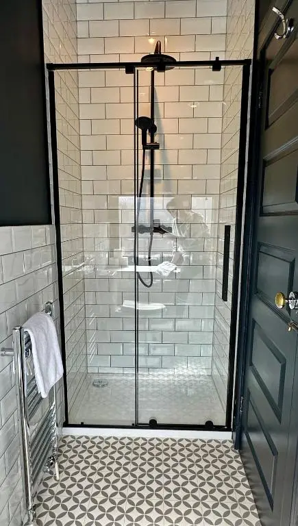 a shower with a glass door in a bathroom at Haugh Hideaway in Inverness