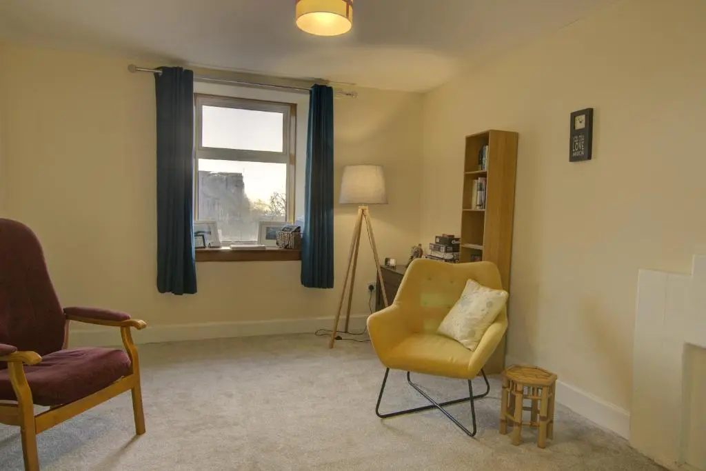 a living room with a chair and a window at Tigh-na-Mara, Helmsdale in Helmsdale
