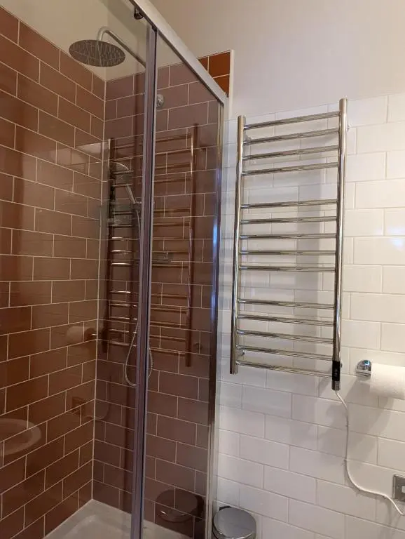 a shower with a glass door in a bathroom at Hootananny in Inverness