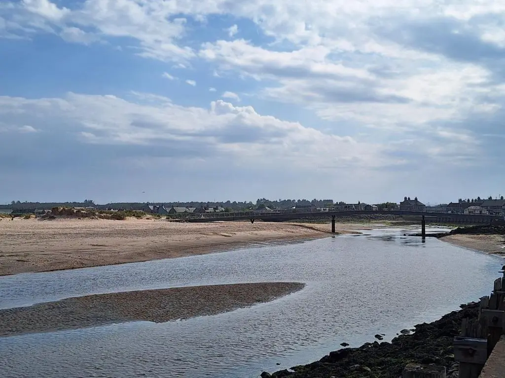a body of water with a bridge in the background at 5 Fulmar Road**Next to West Beach and Golf Course in Lossiemouth