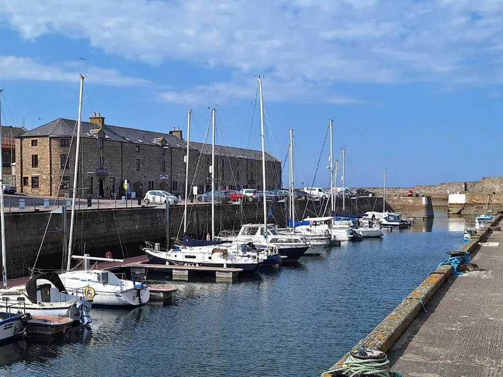a bunch of boats are docked in a harbor at 5 Fulmar Road**Next to West Beach and Golf Course in Lossiemouth