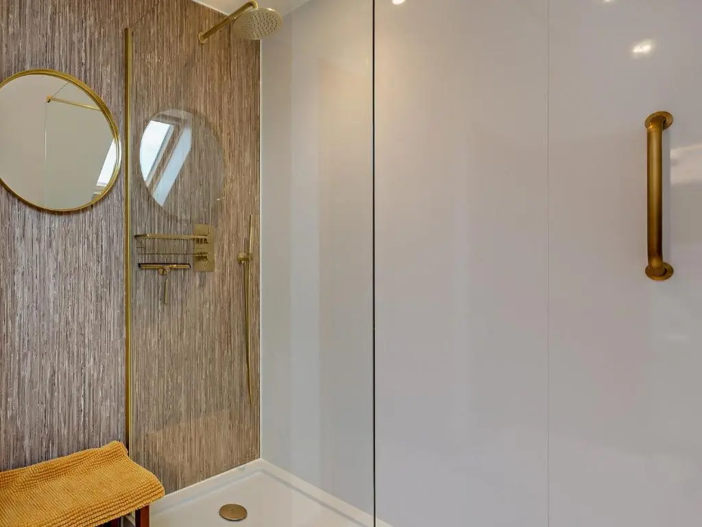 a shower with a glass door and a mirror at 3 Bed in Grantown-on-Spey 94514 in Grantown on Spey