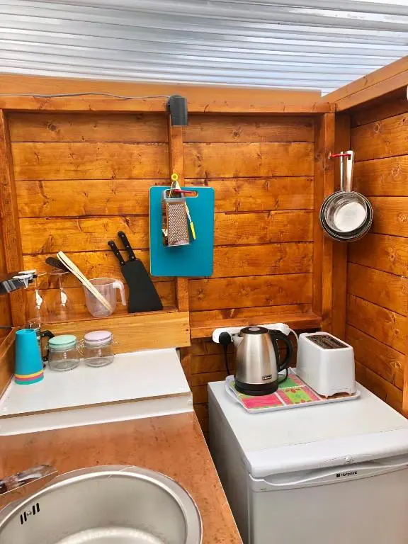 a tiny kitchen with a sink and a stove at Bowtop Wagon at Lettoch Farm in Keith