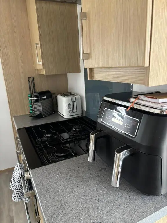 a kitchen with a stove top oven in a kitchen at Silversands Holiday Park in Lossiemouth