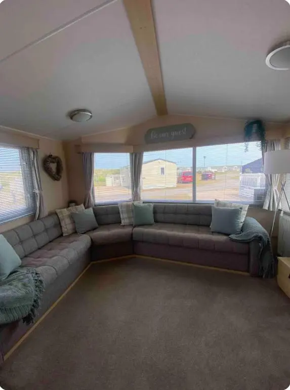 a living room with a couch in a bus at Cozy\u2019s caravan hire in Lossiemouth