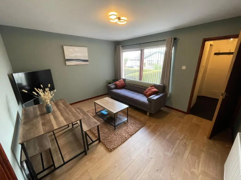 a living room with a couch and a table at Meggies Place in Inverness