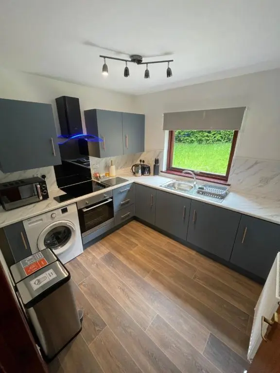 a kitchen with a sink and a window in it at Meggies Place in Inverness