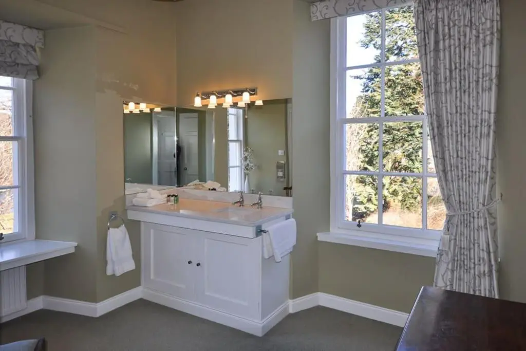 a bathroom with a sink and a mirror at Cray House - Large Country Home in Perthshire in Cray