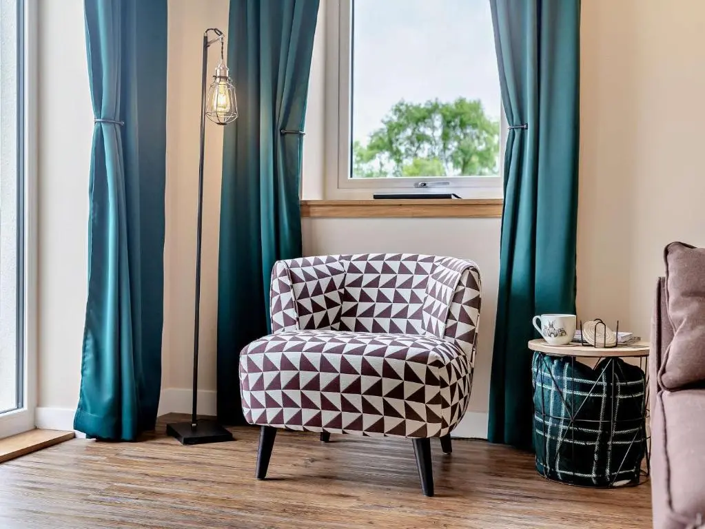 a chair sitting in a room with a window at 2 Bed in Kiltarlity 95056 in Kiltarlty