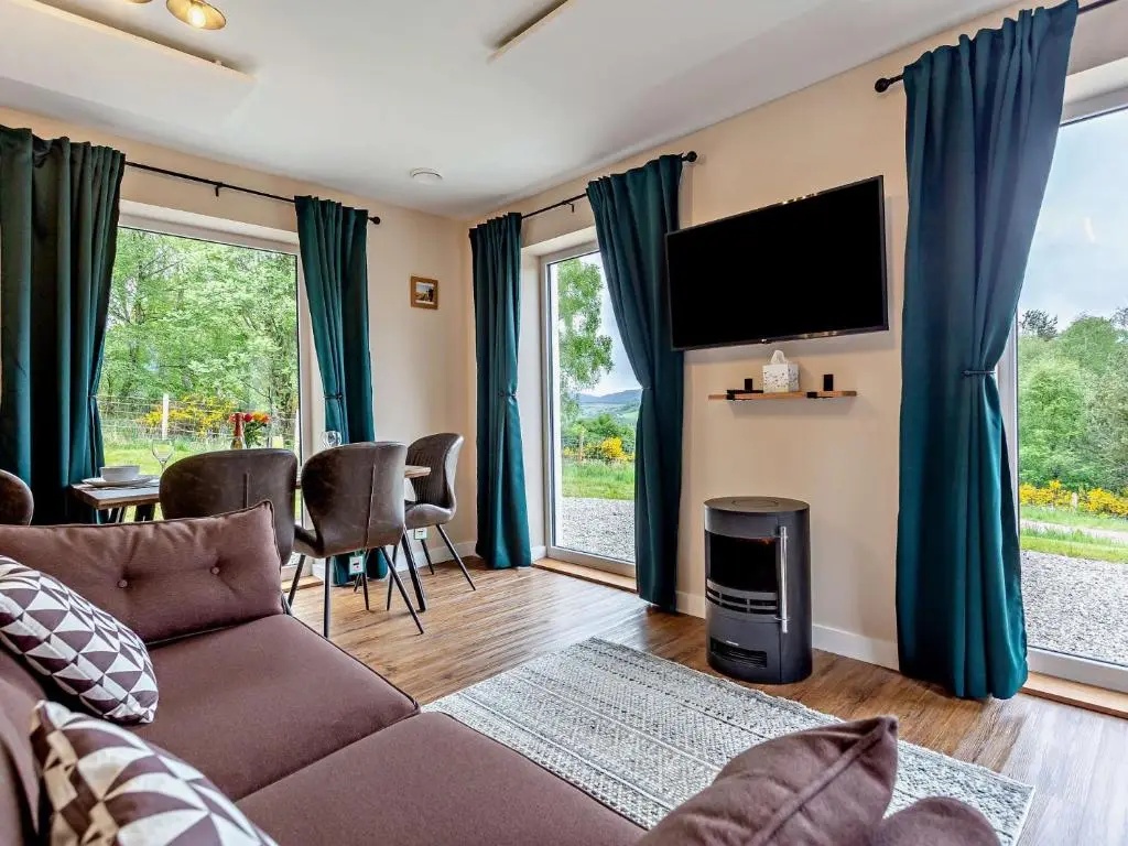 a living room with a couch and a tv at 2 Bed in Kiltarlity 95056 in Kiltarlty