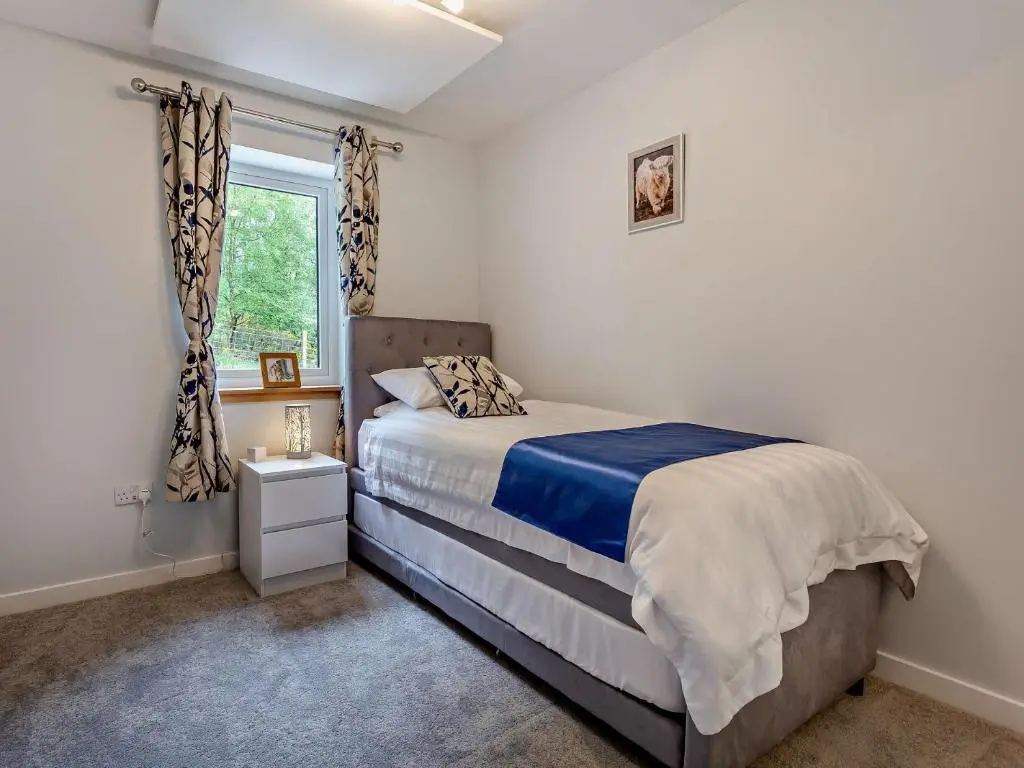 a bedroom with a bed and a window at 2 Bed in Kiltarlity 95056 in Kiltarlty