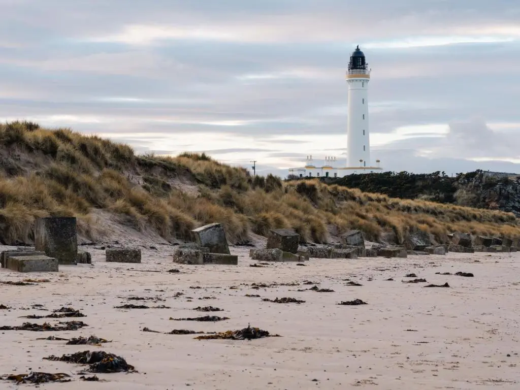 a lighthouse sitting on top of a sandy beach at Apartment Harbour Nights 4 by Interhome in Lossiemouth