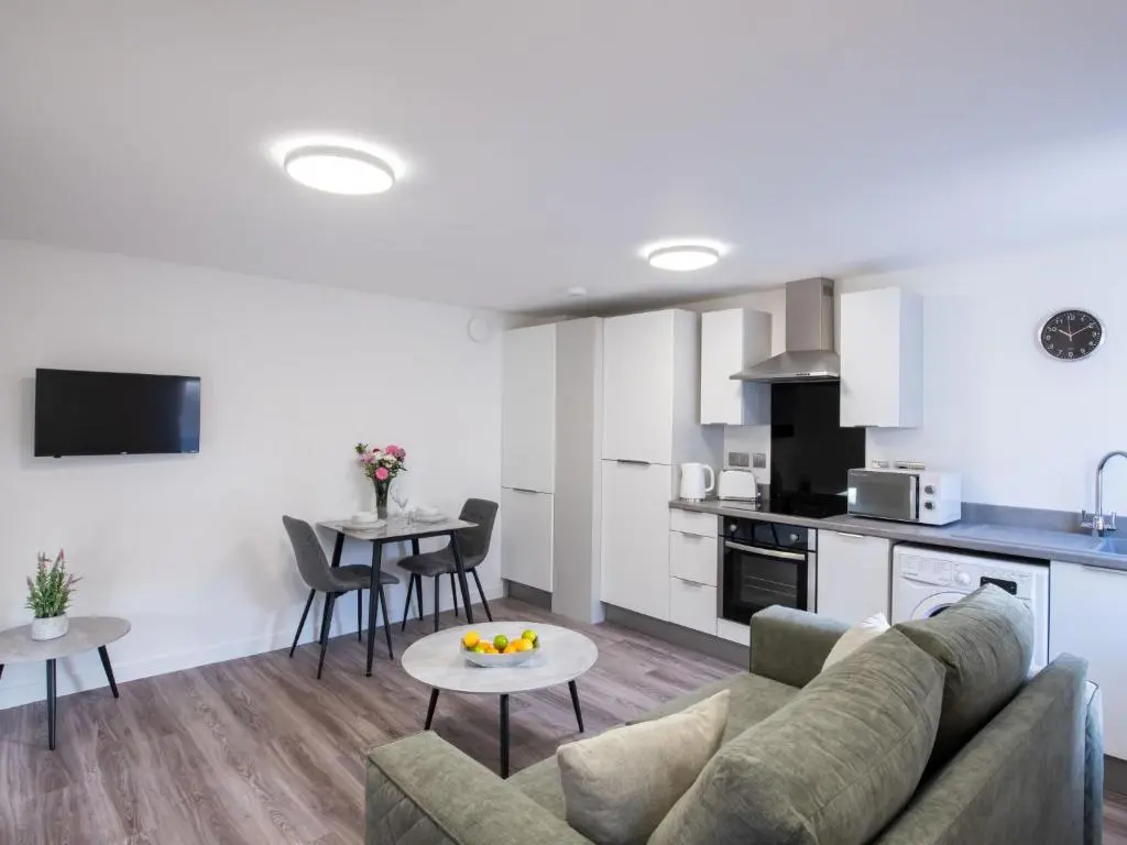 a living room and kitchen with a couch and a table at Apartment Harbour Nights 4 by Interhome in Lossiemouth
