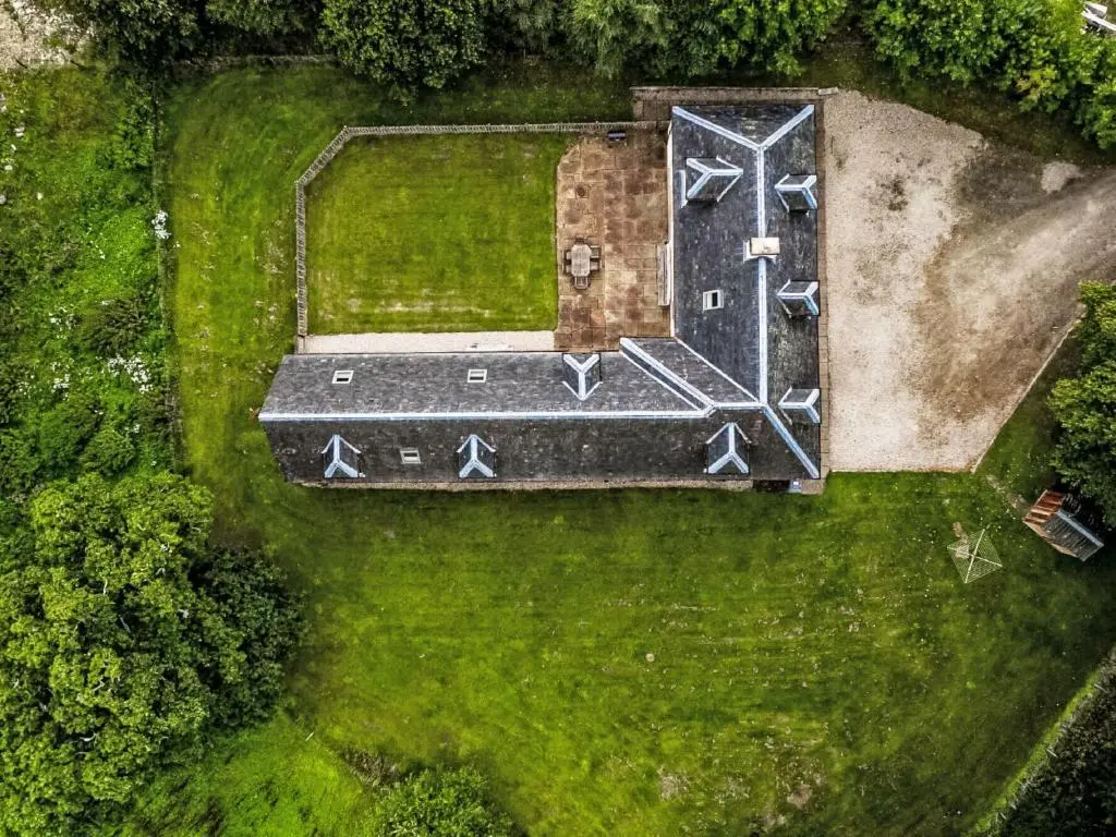 an overhead view of a house with a gate in the grass at Holiday Home Old Stables by Interhome in Drumnadrochit