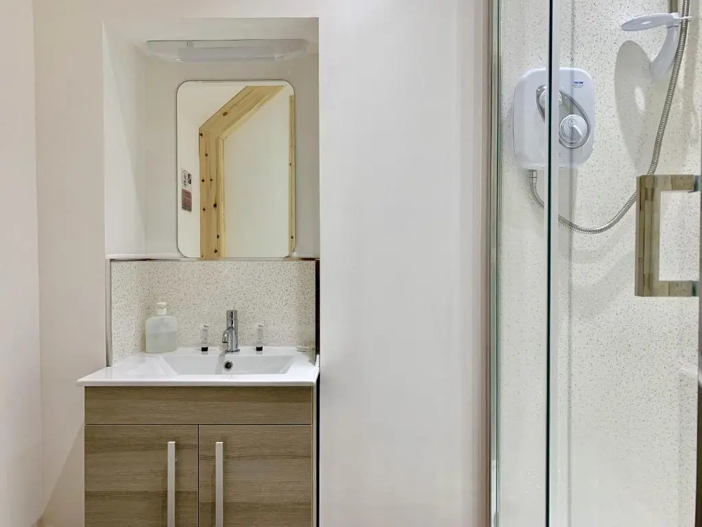 a bathroom with a sink and a mirror at Inverness Holiday House in Dalneigh