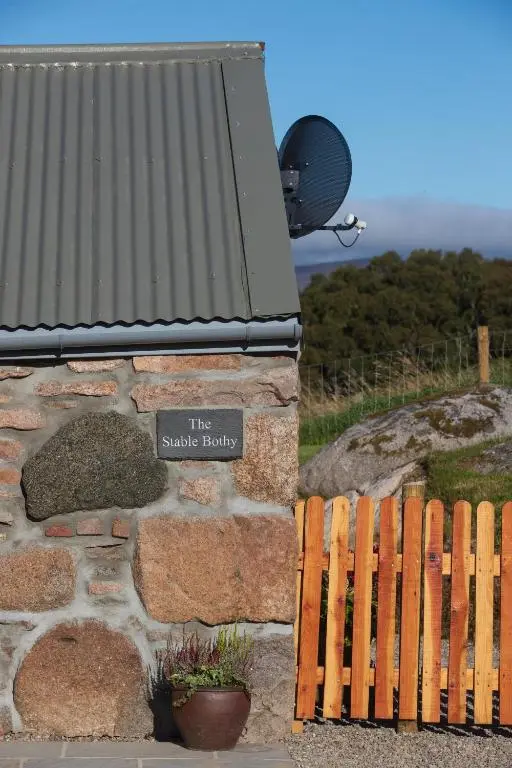 a sign on the side of a stone building at The Stable Bothy in Rogart