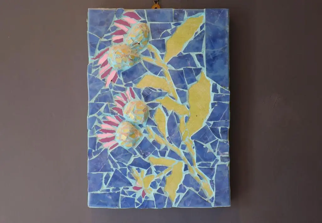 a painting of flowers on top of a wall at Fisherman's Rest in Helmsdale